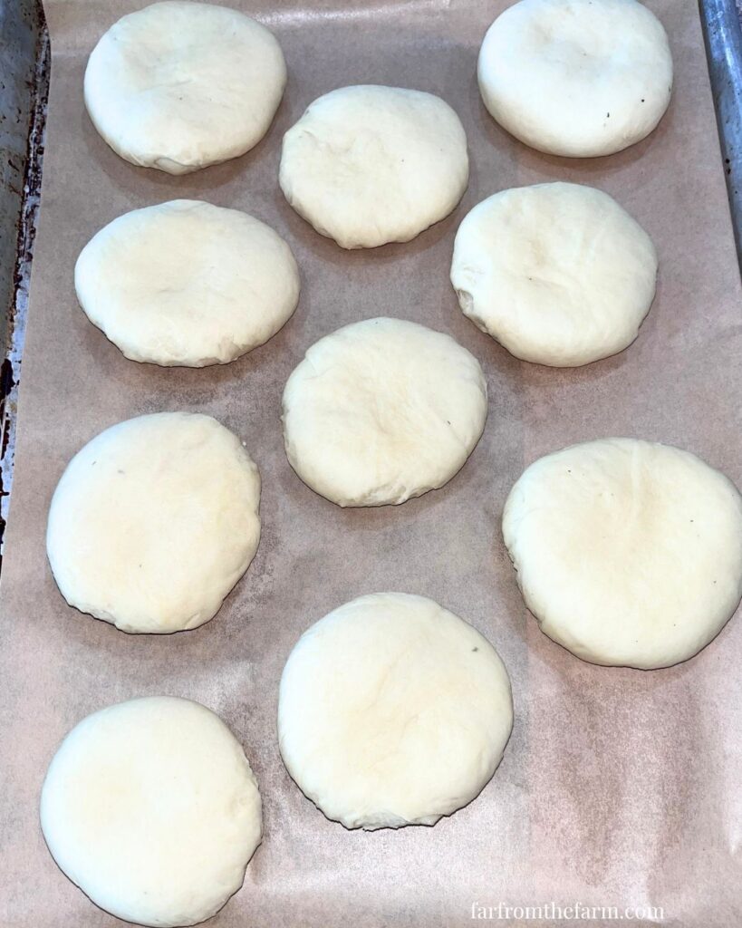 Gentle flatten each dough ball down by gently pressing down on them with the palm of your hand.